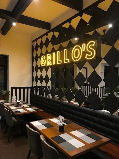 Grillo's Colombo 07 dining space with neon sign